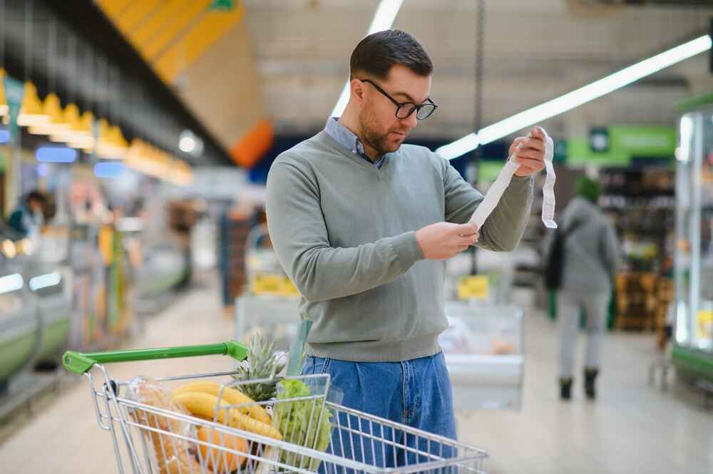 Man looking at His Grocery Cost