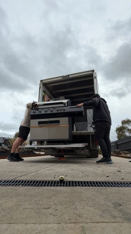 Professional Removalists Loading Goods Into a Truck